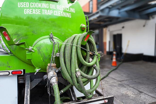 a technician pumping a grease trap in a commercial building in Marlton, NJ